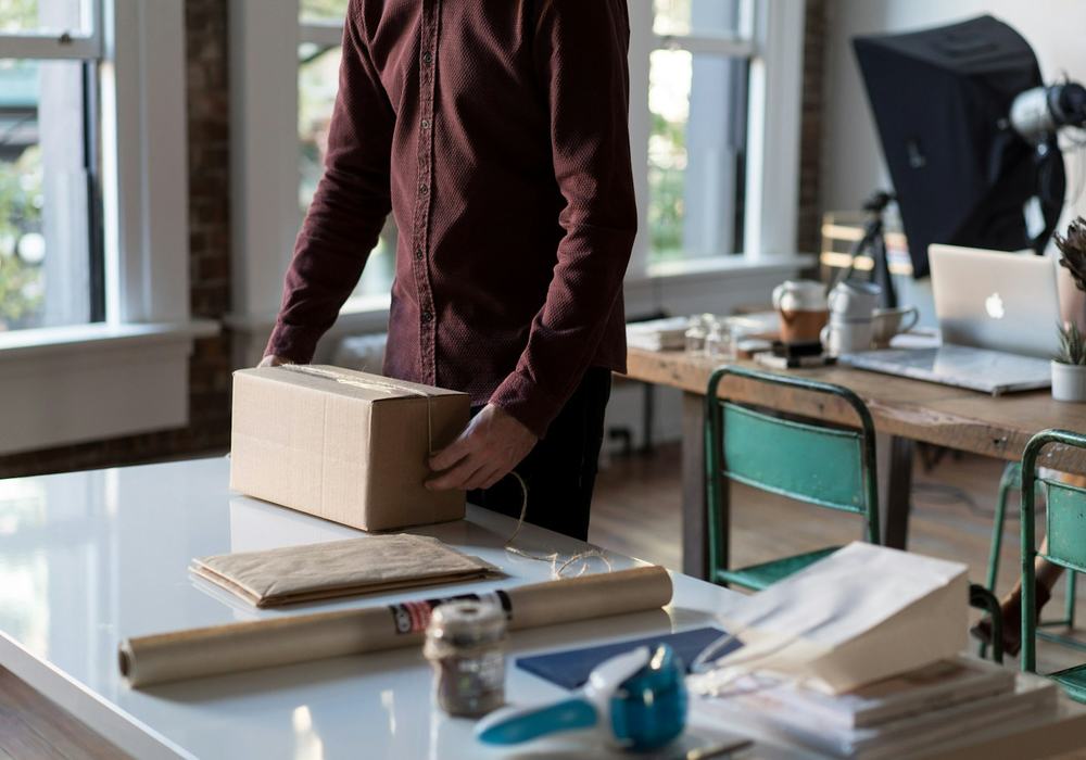 A merchant packing an order at a desk