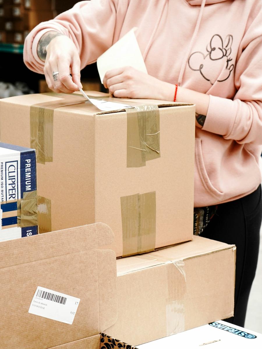 A merchant taping a labelled parcel